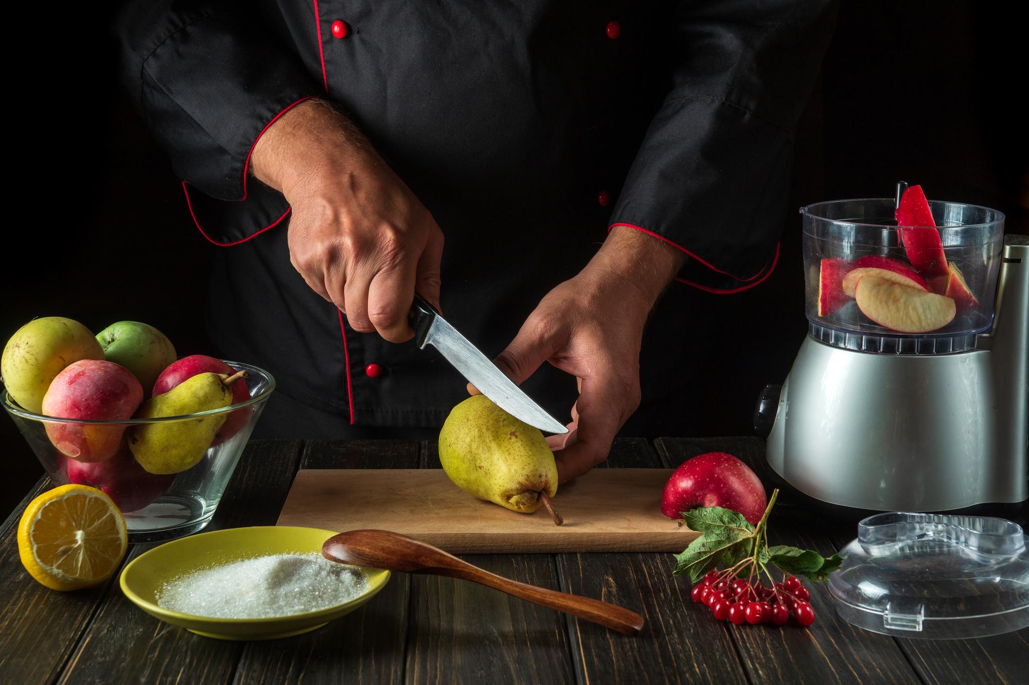 Chef demonstrating knife skills to a small camera setup
